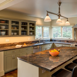 This is an example of a transitional l-shaped kitchen in San Francisco with an undermount sink, shaker cabinets, green cabinets, stainless steel appliances, dark hardwood floors, with island, brown floor, brown benchtop and granite benchtops.