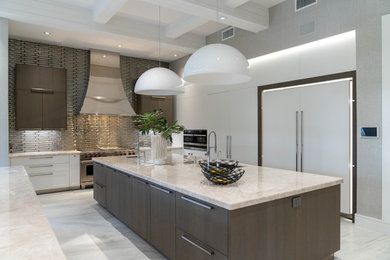 Huge transitional l-shaped porcelain tile and gray floor enclosed kitchen photo in Miami with an undermount sink, flat-panel cabinets, medium tone wood cabinets, quartzite countertops, metallic backsplash, glass tile backsplash, paneled appliances, two islands and beige countertops