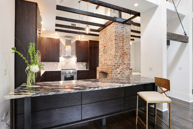 Inspiration for a large transitional u-shaped dark wood floor and brown floor open concept kitchen remodel in New Orleans with a single-bowl sink, flat-panel cabinets, dark wood cabinets, marble countertops, white backsplash, marble backsplash, paneled appliances, an island and white countertops