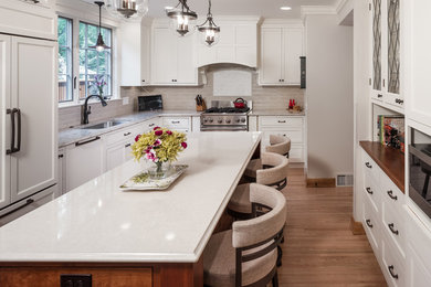 Inspiration for a contemporary kitchen remodel in Minneapolis with white cabinets