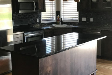 Mid-sized transitional l-shaped laminate floor and beige floor eat-in kitchen photo in Other with raised-panel cabinets, dark wood cabinets, ceramic backsplash and an island