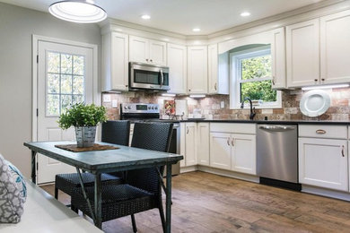 Kitchen - transitional kitchen idea in Louisville with white cabinets, granite countertops, stone tile backsplash and stainless steel appliances
