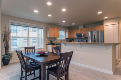 Elegant l-shaped eat-in kitchen photo in Seattle with shaker cabinets, light wood cabinets, stainless steel appliances and an island