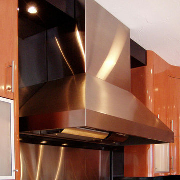 Stainless chimney hood trimmed with black laminated soffit