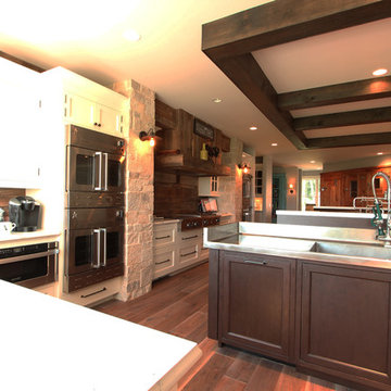 Stainless Steel Countertop with Reclaimed Beams in Large Kitchen