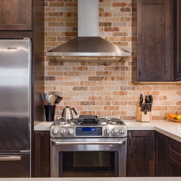 Stainless Steel Stove and Range Hood In Rustic Cooking Area