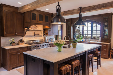 Eat-in kitchen - traditional limestone floor eat-in kitchen idea in New York with a farmhouse sink, shaker cabinets, distressed cabinets, marble countertops, beige backsplash, stainless steel appliances and an island