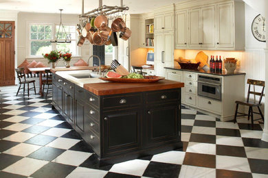 Eat-in kitchen - mid-sized farmhouse single-wall ceramic tile and multicolored floor eat-in kitchen idea in Newark with an undermount sink, raised-panel cabinets, white cabinets, granite countertops, white backsplash, wood backsplash, stainless steel appliances and an island