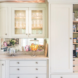 Design ideas for a small traditional l-shaped eat-in kitchen in Berkshire with a farmhouse sink, shaker cabinets, grey cabinets, limestone benchtops, mirror splashback, panelled appliances, ceramic floors and no island.