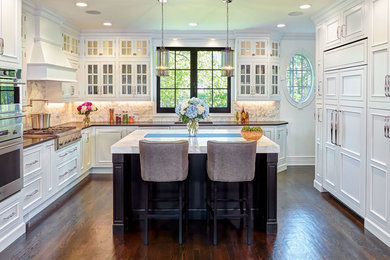 Inspiration for a large timeless u-shaped dark wood floor and brown floor eat-in kitchen remodel in Other with an undermount sink, beaded inset cabinets, white cabinets, beige backsplash, paneled appliances and an island