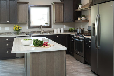 Example of a mid-sized transitional l-shaped eat-in kitchen design in Other with a drop-in sink, recessed-panel cabinets, dark wood cabinets, stainless steel appliances and an island