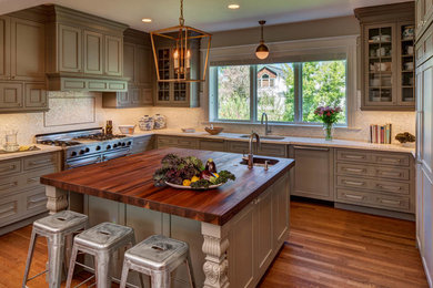 Example of a large transitional u-shaped medium tone wood floor eat-in kitchen design in Denver with an undermount sink, beaded inset cabinets, gray cabinets, wood countertops, white backsplash, mosaic tile backsplash, paneled appliances and an island
