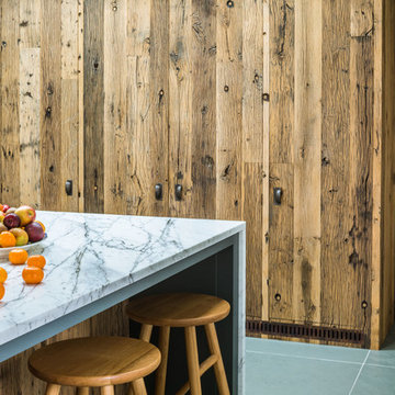 Steel and Marble Kitchen with Reclaimed Wood Feature