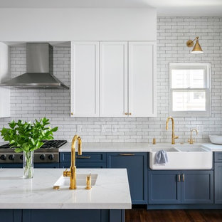 Transitional kitchen ideas - Kitchen - transitional brown floor and dark wood floor kitchen idea in San Francisco with a farmhouse sink, quartz countertops, white backsplash, stainless steel appliances, an island, white countertops, shaker cabinets, blue cabinets and subway tile backsplash