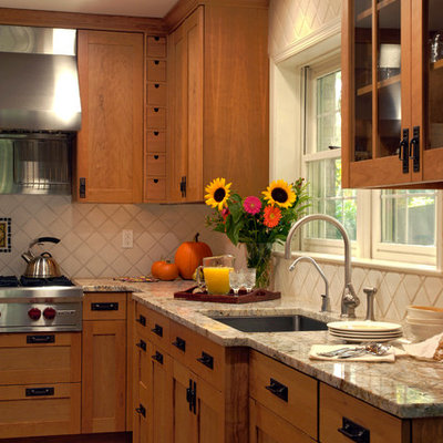 Example of a mid-sized arts and crafts u-shaped light wood floor eat-in kitchen design in DC Metro with an undermount sink, glass-front cabinets, medium tone wood cabinets, granite countertops, multicolored backsplash, mosaic tile backsplash, stainless steel appliances and an island