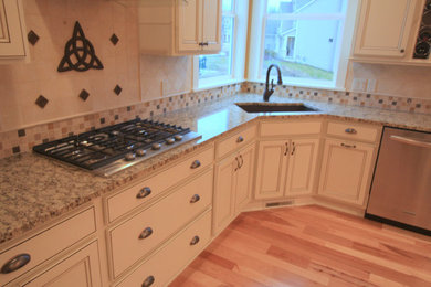 Transitional light wood floor kitchen pantry photo in Grand Rapids with a drop-in sink, raised-panel cabinets, white cabinets and beige backsplash