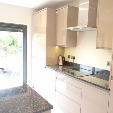 'Stone' gloss & 'Elm effect' handleless kitchen with 'Blue Pearl' granite wtops