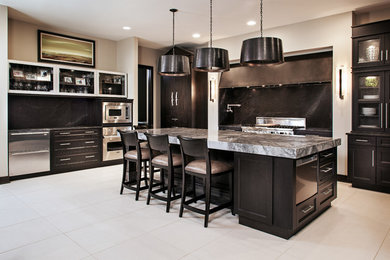 Example of a large minimalist u-shaped kitchen design in Other with black cabinets, stainless steel appliances and an island