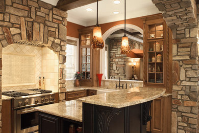 Enclosed kitchen - mid-sized traditional l-shaped medium tone wood floor and brown floor enclosed kitchen idea with a farmhouse sink, glass-front cabinets, medium tone wood cabinets, granite countertops, white backsplash, mosaic tile backsplash, stainless steel appliances and an island