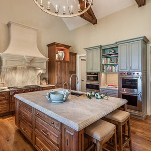 Huge traditional enclosed kitchen remodeling - Inspiration for a huge timeless medium tone wood floor enclosed kitchen remodel in Other with an undermount sink, raised-panel cabinets, medium tone wood cabinets, quartzite countertops, porcelain backsplash, an island, gray backsplash, stainless steel appliances and gray countertops