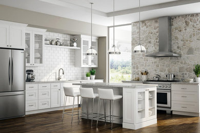 Design ideas for a large contemporary l-shaped open plan kitchen in DC Metro with a submerged sink, shaker cabinets, white cabinets, marble worktops, white splashback, metro tiled splashback, stainless steel appliances, dark hardwood flooring, an island and brown floors.