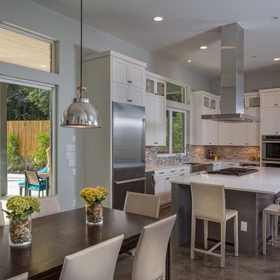 Trendy eat-in kitchen photo in Austin with matchstick tile backsplash, stainless steel appliances, multicolored backsplash and white cabinets