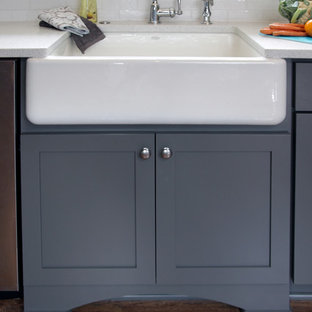 Mid-sized transitional eat-in kitchen ideas - Eat-in kitchen - mid-sized transitional u-shaped dark wood floor and brown floor eat-in kitchen idea in Milwaukee with a farmhouse sink, shaker cabinets, gray cabinets, white backsplash, subway tile backsplash, stainless steel appliances, a peninsula, quartzite countertops and gray countertops