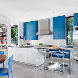 Contemporary eat-in kitchen ideas - Trendy galley eat-in kitchen photo in Austin with flat-panel cabinets, blue cabinets, stainless steel appliances and an island