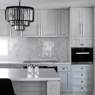This is an example of a large traditional galley eat-in kitchen in Sydney with an undermount sink, raised-panel cabinets, grey cabinets, quartz benchtops, grey splashback, porcelain splashback, black appliances, marble floors, with island, grey floor and yellow benchtop.