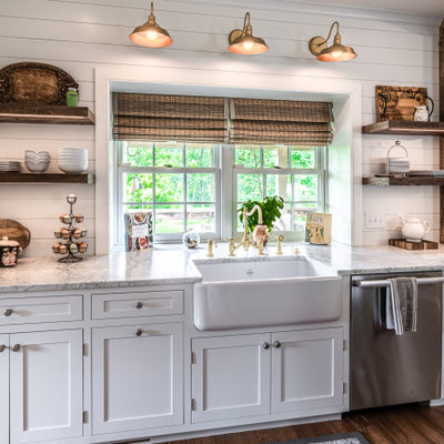Eat-in kitchen - mid-sized country u-shaped light wood floor eat-in kitchen idea in Philadelphia with a farmhouse sink, shaker cabinets, white cabinets, quartz countertops, white backsplash, stainless steel appliances, an island and white countertops