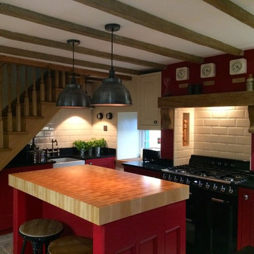 Striking red traditional kitchen in  Georgian cottage
