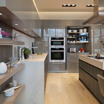 Trendy light wood floor eat-in kitchen photo in DC Metro with flat-panel cabinets, white backsplash, an island, an undermount sink, beige cabinets, stone slab backsplash and paneled appliances