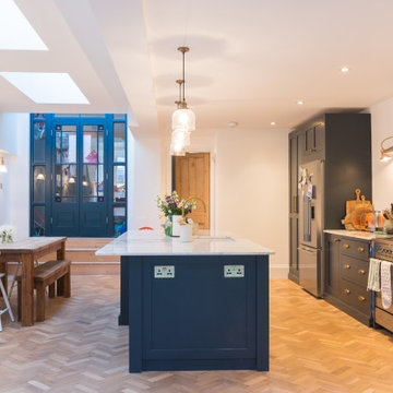 Stunning dark blue open plan kitchen with large island and white quartz worktops