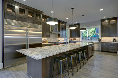 Eat-in kitchen - large modern medium tone wood floor and gray floor eat-in kitchen idea in DC Metro with a drop-in sink, shaker cabinets, dark wood cabinets, granite countertops, gray backsplash, marble backsplash, stainless steel appliances, an island and gray countertops