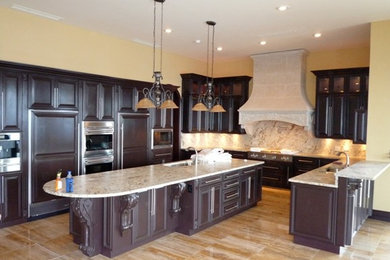 Example of a large u-shaped travertine floor kitchen design in Other with raised-panel cabinets, brown cabinets, granite countertops and an island