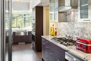 Eat-in kitchen - small modern galley ceramic tile eat-in kitchen idea in Denver with an undermount sink, flat-panel cabinets, dark wood cabinets, granite countertops, multicolored backsplash, stone slab backsplash, stainless steel appliances and no island