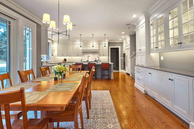 Eat-in kitchen - large transitional l-shaped medium tone wood floor and brown floor eat-in kitchen idea in Bridgeport with a drop-in sink, beaded inset cabinets, white cabinets, limestone countertops, white backsplash, ceramic backsplash, stainless steel appliances, an island and gray countertops