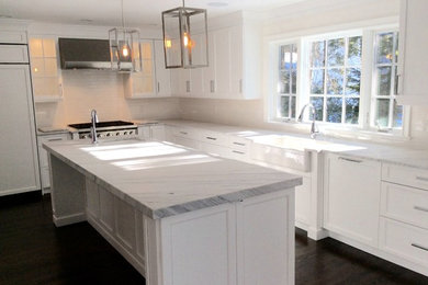 Eat-in kitchen - large transitional l-shaped dark wood floor eat-in kitchen idea in New York with a farmhouse sink, shaker cabinets, white cabinets, marble countertops, white backsplash, subway tile backsplash, stainless steel appliances and an island