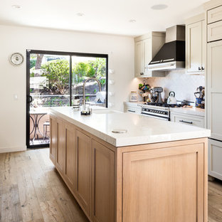 Design ideas for a small transitional galley eat-in kitchen in Los Angeles with a farmhouse sink, shaker cabinets, beige cabinets, quartz benchtops, beige splashback, ceramic splashback, stainless steel appliances, light hardwood floors, with island, beige floor and beige benchtop.
