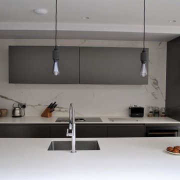 Stylish modern handleless kitchen in dark grey
