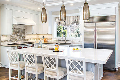 Kitchen - transitional l-shaped medium tone wood floor kitchen idea in New York with an undermount sink, shaker cabinets, white cabinets, quartz countertops, gray backsplash, mosaic tile backsplash, stainless steel appliances and an island