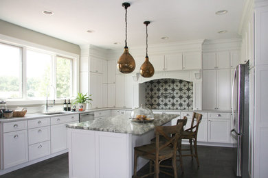 Eat-in kitchen - mid-sized traditional u-shaped porcelain tile and brown floor eat-in kitchen idea in Cleveland with an undermount sink, shaker cabinets, white cabinets, quartz countertops, beige backsplash, ceramic backsplash, stainless steel appliances and an island
