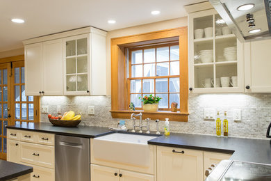 Inspiration for a transitional u-shaped medium tone wood floor eat-in kitchen remodel in Boston with a farmhouse sink, recessed-panel cabinets, white cabinets, solid surface countertops, white backsplash, stainless steel appliances and no island