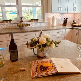 Mid-sized country l-shaped eat-in kitchen in Other with a farmhouse sink, glass-front cabinets, white cabinets, granite benchtops, white splashback, porcelain splashback, stainless steel appliances, dark hardwood floors, with island, brown floor and green benchtop.