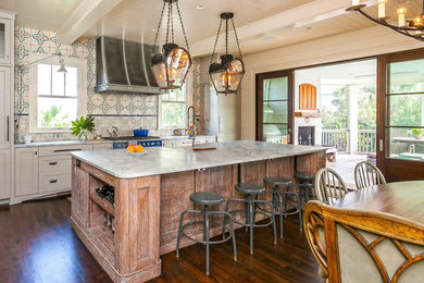 Eat-in kitchen - large dark wood floor and brown floor eat-in kitchen idea in Charleston with white cabinets and an island