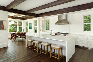 Open concept kitchen - large farmhouse galley dark wood floor open concept kitchen idea in Charleston with a farmhouse sink, white cabinets, marble countertops, white backsplash, stone tile backsplash, stainless steel appliances, an island and recessed-panel cabinets