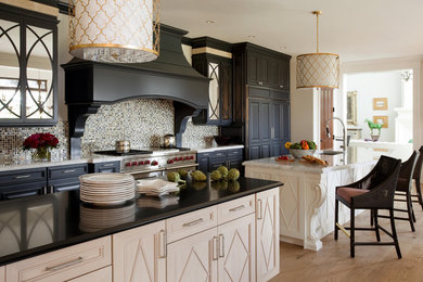 Kitchen - contemporary kitchen idea in Boston with black cabinets, paneled appliances and metallic backsplash