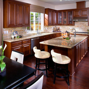 Large transitional open concept kitchen photos - Large transitional l-shaped dark wood floor open concept kitchen photo in San Francisco with an undermount sink, raised-panel cabinets, white cabinets, granite countertops, beige backsplash, stainless steel appliances and an island