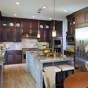 Large transitional eat-in kitchen designs - Eat-in kitchen - large transitional u-shaped eat-in kitchen idea in San Francisco with an undermount sink, raised-panel cabinets, dark wood cabinets, granite countertops, beige backsplash, mosaic tile backsplash, stainless steel appliances and an island