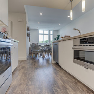 Open concept kitchen ideas - Inspiration for a l-shaped open concept kitchen remodel in San Francisco with shaker cabinets, white cabinets, stainless steel appliances and an island